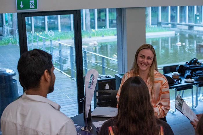 Attendees conversing with a company at the WESA Spring Conference